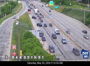 Emergency vehicle and cones on the right shoulder of I-94 near 85th Street.