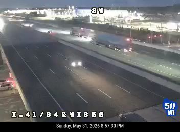 Emergency vehicle with lights on the shoulder of the highway.