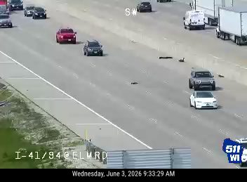 Debris scattered across multiple lanes of highway traffic.