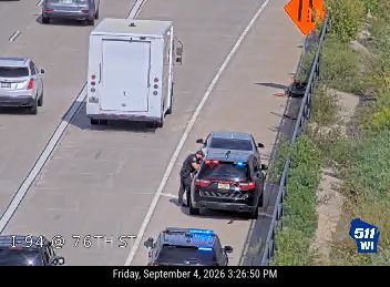 Police car with lights on the shoulder