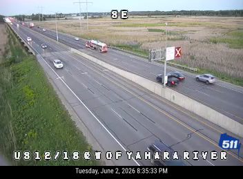 Fire truck and other vehicles stopped on the highway, possibly responding to an incident.