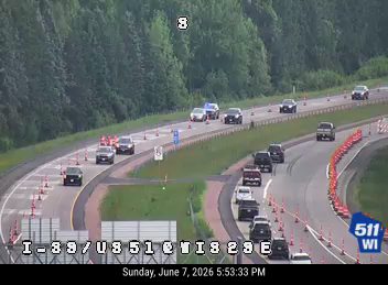 Emergency responders and vehicles are present on the roadway, indicating an incident.