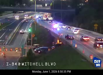 Emergency responders with flashing lights on I-94 at Mitchell Blvd.