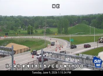 Emergency responders and vehicles are present on the roadway, indicating an incident.