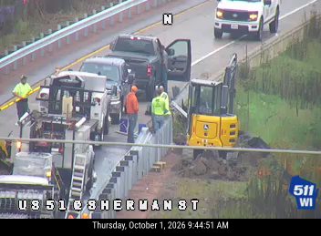 Construction workers and equipment on the right shoulder