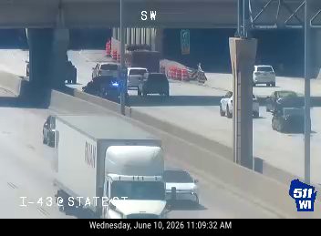 Emergency responders and vehicles are present on the roadway, indicating an incident.