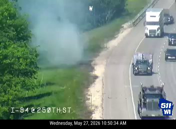 Smoke or dust plume visible on the side of the highway near I-94.