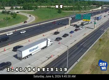 Emergency responders and vehicles are present on the highway shoulder.