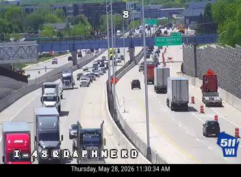 Emergency responders and cones on the right shoulder of the highway.