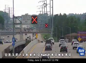 Emergency responders on scene with red X signs indicating lane closure.
