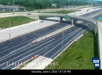 Debris and orange cones are present on the roadway, indicating a possible incident.