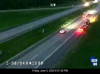 Car stopped on highway with hazard lights on, possibly a crash.