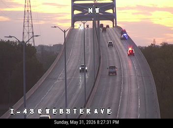 Police and fire vehicles on the highway, possibly responding to an incident.