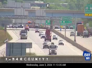 Emergency responders and vehicles are present on the highway, indicating an incident.