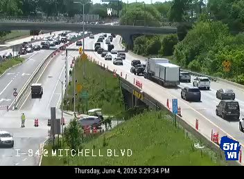 Emergency responder with cones on the shoulder of I-94 at Mitchell Blvd.