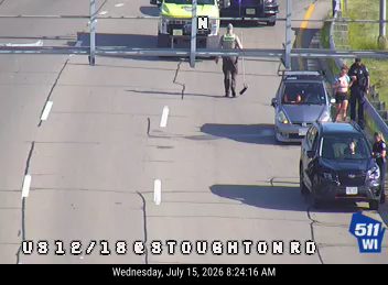 Person with broom on the roadway