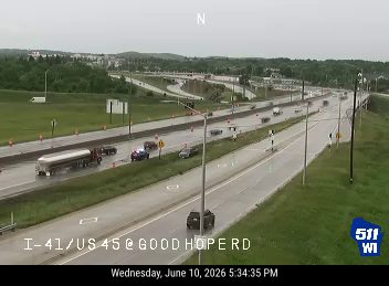 Police car and emergency lights visible on the highway shoulder.
