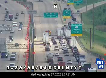 Emergency responders and vehicles are present on the highway, indicating an incident.