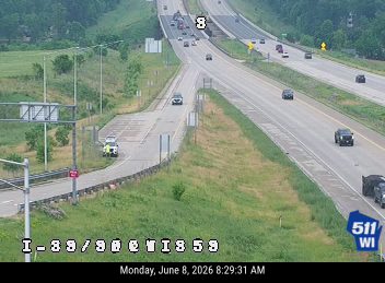Police vehicle and possibly other responders on the shoulder of the highway.