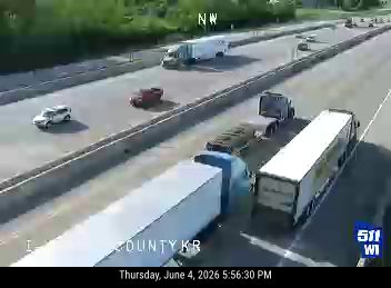 Multiple vehicles stopped on highway, appears to be a multi-vehicle accident.