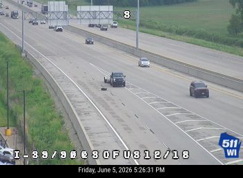 A dark object, possibly debris, is on the roadway in the right lane.