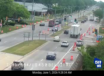Emergency vehicles and cones indicate a responder incident on the roadway.