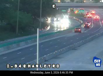 Emergency responders on I-94 at Hayley Rd with flashing lights visible.