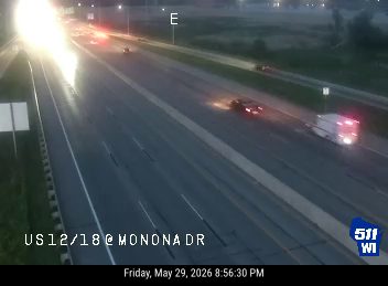 Ambulance and car stopped on the right shoulder of the highway.