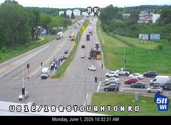 Multiple vehicles involved in a crash on a highway with debris visible.