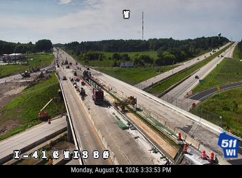 Construction equipment and workers in the right lane
