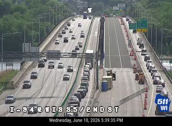 Construction and lane closure on I-94 with workers and equipment present.