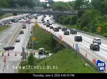 Emergency responders and vehicles are present on the roadway, indicating an incident.