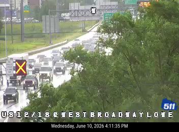 Two vehicles appear to be involved in a crash on the wet roadway.