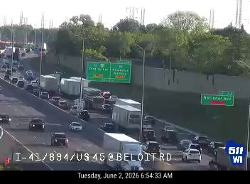 Emergency responders and vehicles are present on the highway, indicating an incident.