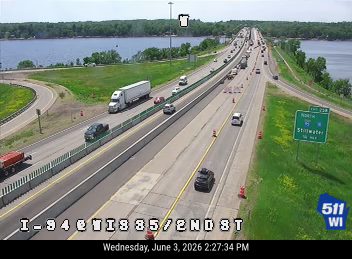 Emergency responders and cones on the highway, indicating a possible incident or closure.
