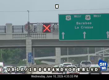 Emergency vehicle with flashing lights on the overpass, likely responding to an incident.