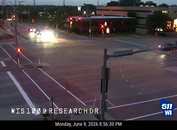 Emergency vehicles with flashing lights are present at the intersection.