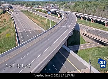 Emergency responders and vehicles are present on the roadway, indicating an incident.