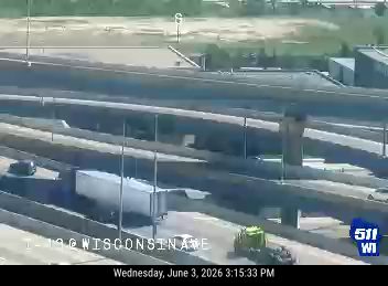 Construction vehicle and equipment on the roadway, possibly responding to an incident.
