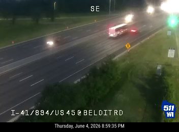A bus is stopped on the highway, possibly a responder incident.