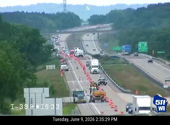 Road work with cones and a truck on the highway.