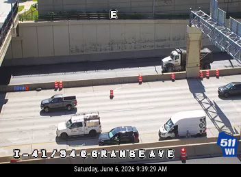 Emergency vehicle and cones on the roadway, indicating a potential incident response.