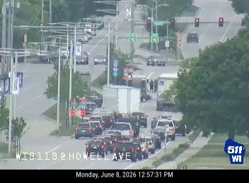 Emergency responders and vehicles are present on the roadway, indicating an incident.