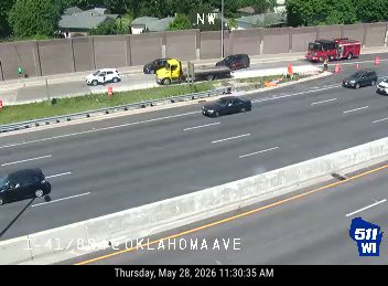 Fire truck and other vehicles on the side of the highway, possibly responding to an incident.